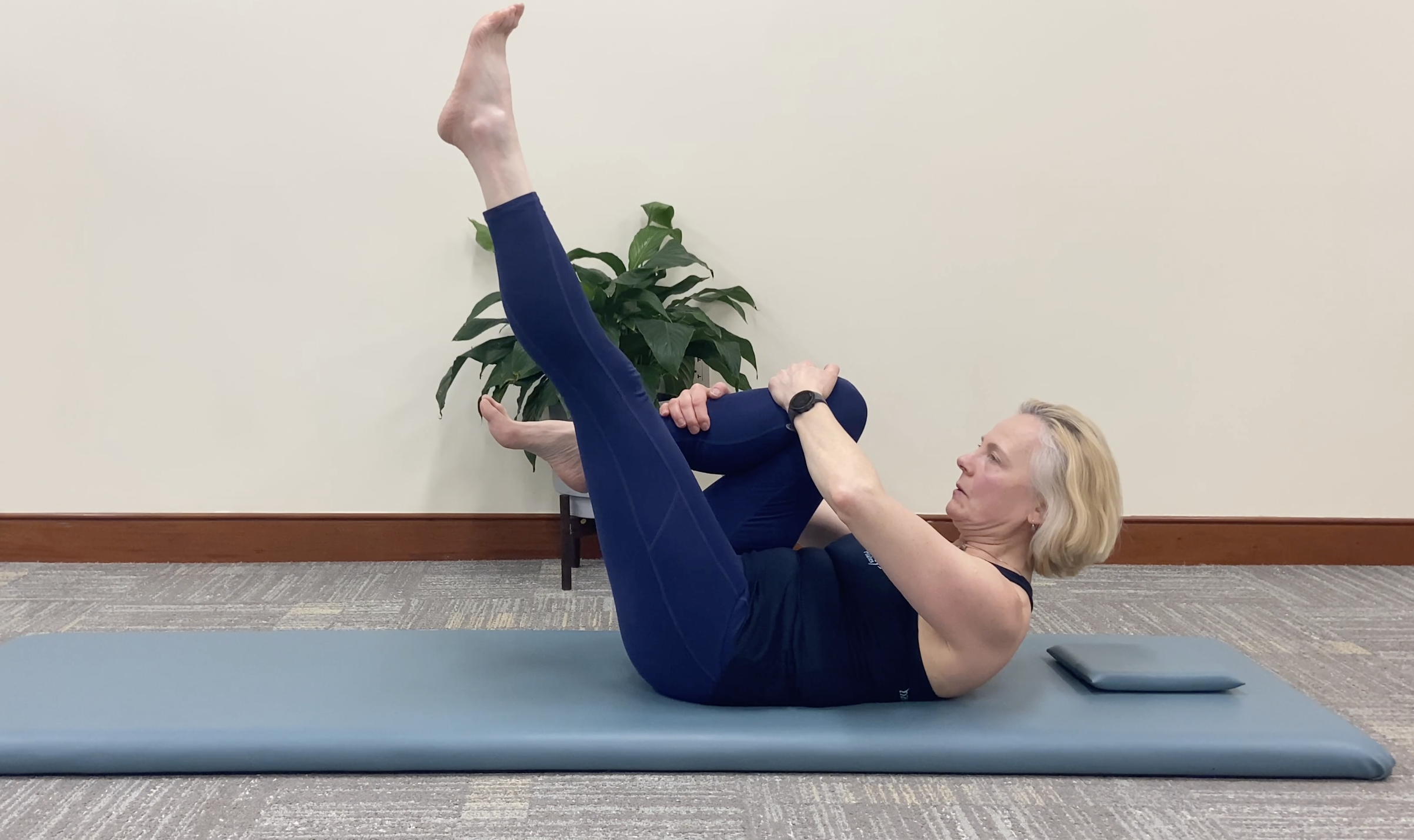 a woman performing Pilates exercise